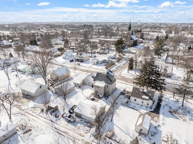 snowy aerial view with a residential view