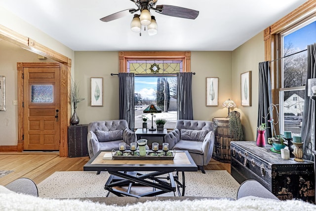 living room with wood finished floors and ceiling fan