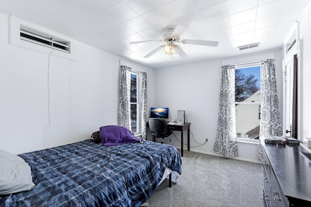 bedroom with visible vents, multiple windows, carpet, and a ceiling fan