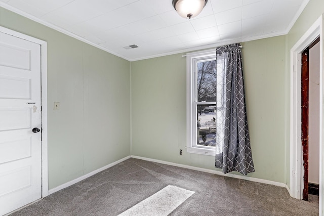 empty room with visible vents, baseboards, ornamental molding, and carpet flooring