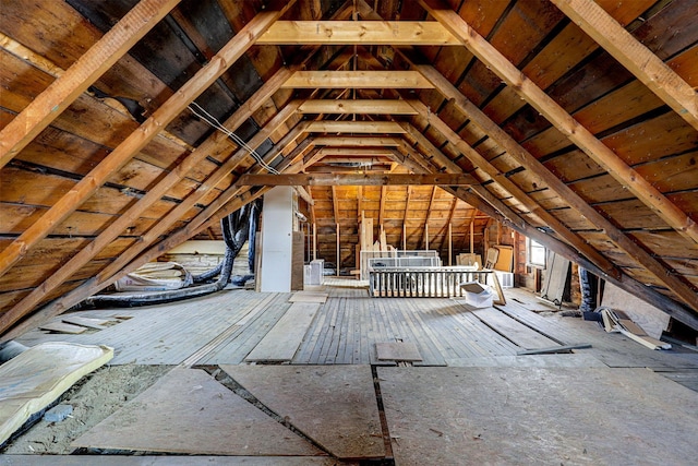 unfinished attic with an upstairs landing