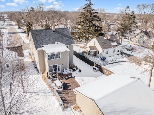 snowy aerial view with a residential view