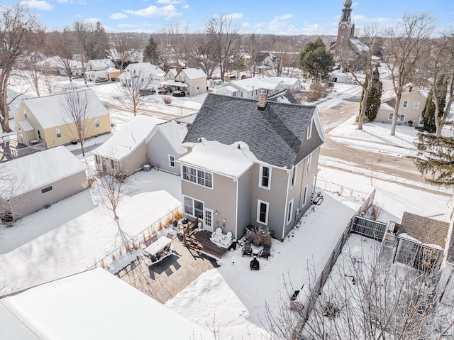 snowy aerial view with a residential view