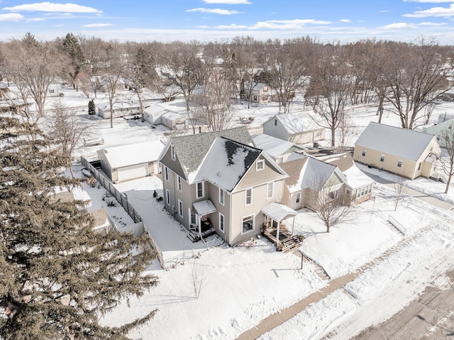 snowy aerial view featuring a residential view