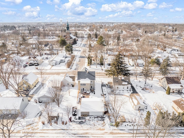 snowy aerial view featuring a residential view