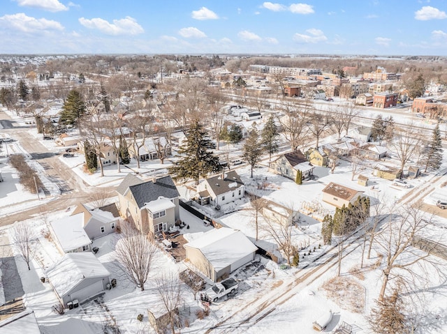 snowy aerial view with a residential view