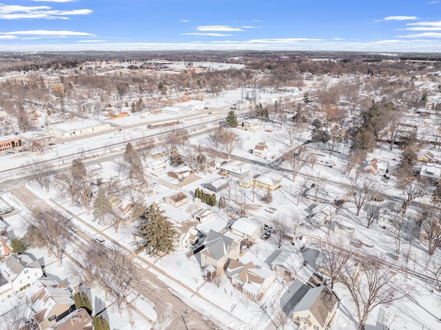 snowy aerial view with a residential view