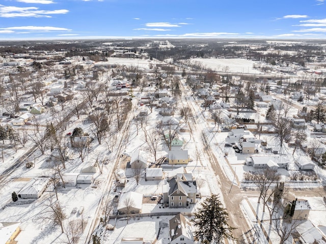 snowy aerial view with a residential view