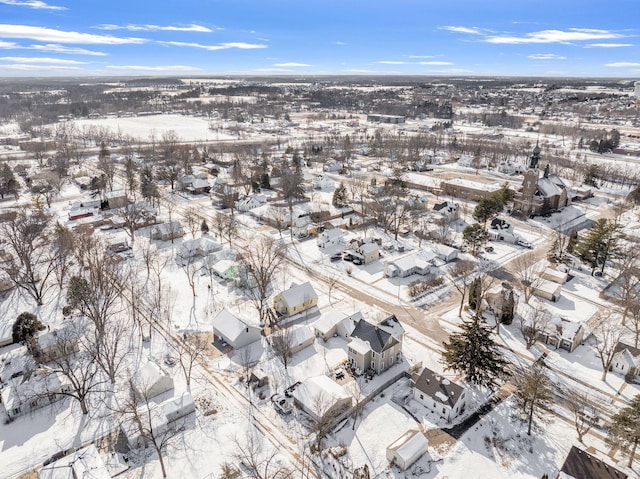 snowy aerial view featuring a residential view