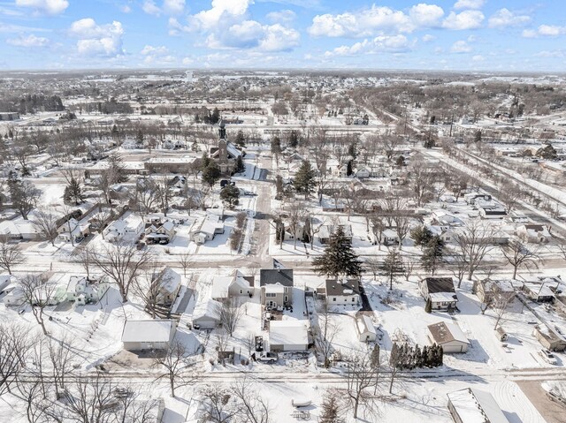 snowy aerial view with a residential view