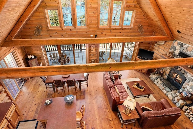 living room featuring high vaulted ceiling and hardwood / wood-style flooring