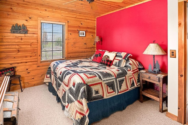 carpeted bedroom with wooden walls and wood ceiling