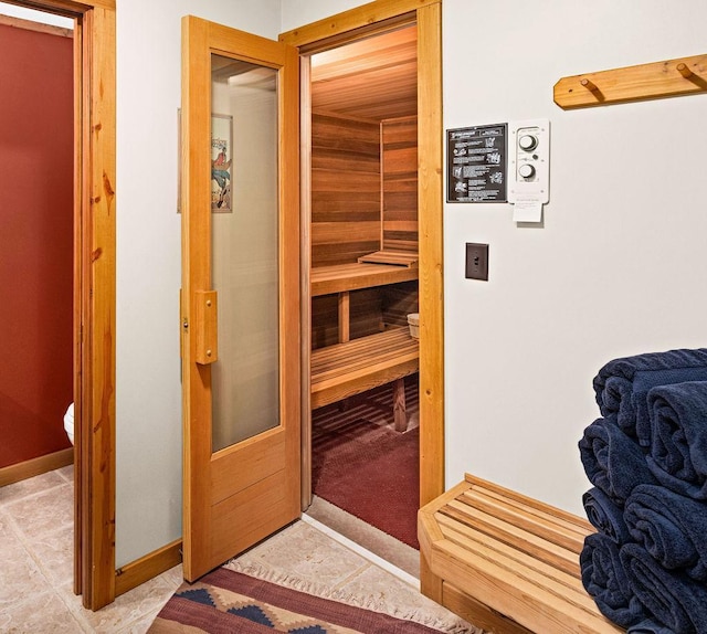 view of sauna featuring tile patterned flooring and baseboards