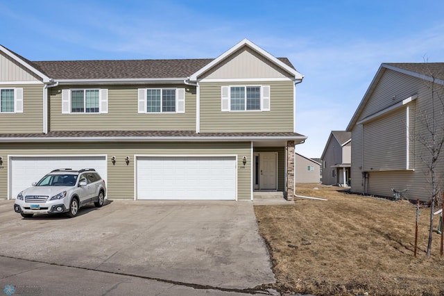 view of front of property with driveway, a shingled roof, a garage, and board and batten siding