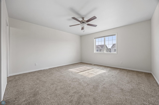 unfurnished room with baseboards, carpet, and a ceiling fan