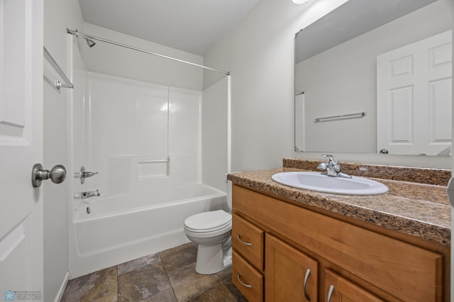 bathroom featuring stone finish flooring, shower / bathtub combination, toilet, and vanity