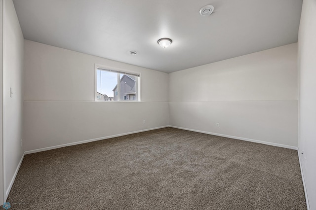 empty room featuring baseboards and carpet floors