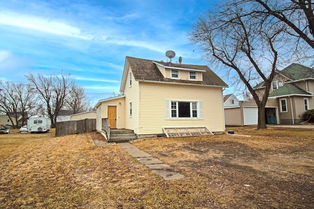 exterior space featuring a shingled roof and fence