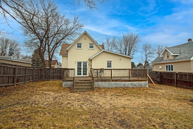 rear view of property featuring french doors, a deck, and a fenced backyard