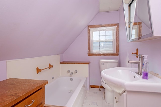 bathroom with baseboards, toilet, lofted ceiling, a bath, and vanity