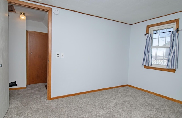 empty room with baseboards, light carpet, and ornamental molding