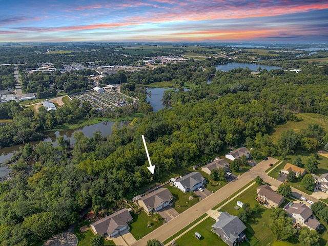 bird's eye view featuring a forest view and a water view