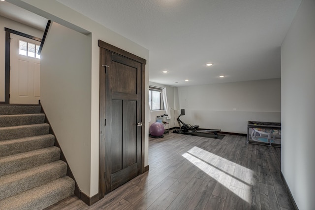 exercise area with recessed lighting, baseboards, and wood finished floors