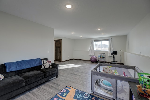 living area with recessed lighting, light wood-style floors, and baseboards