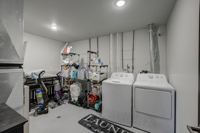 laundry room featuring recessed lighting, laundry area, and washing machine and clothes dryer