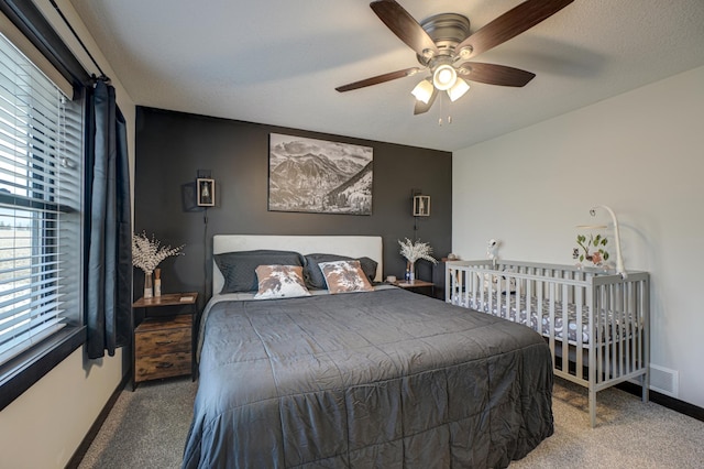 bedroom with carpet floors, baseboards, ceiling fan, and visible vents