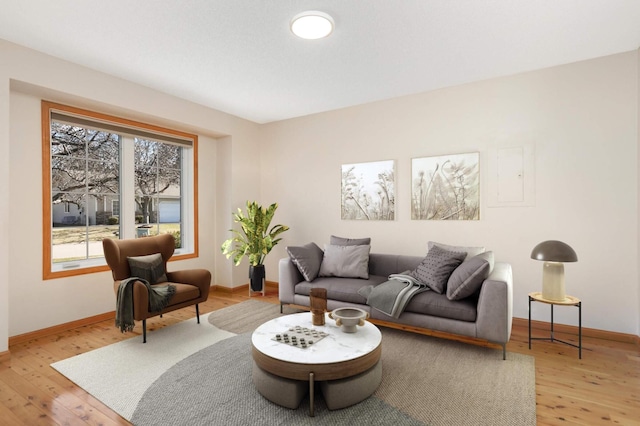living area featuring light wood-style flooring and baseboards