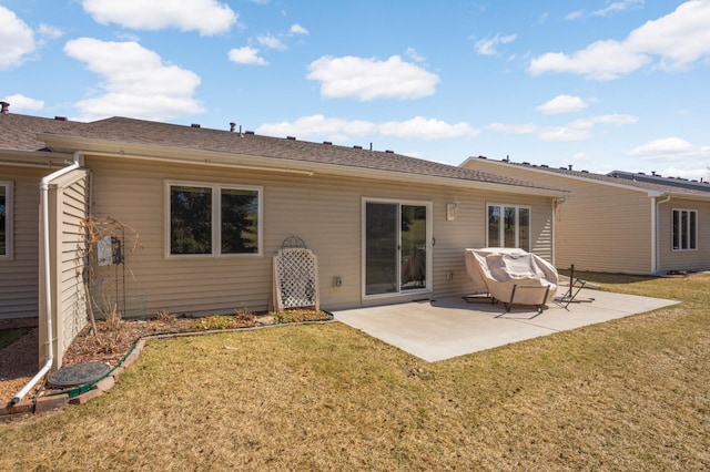 back of property featuring a yard and a patio area