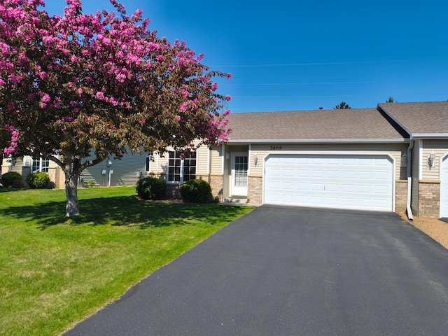 3605 Zinnia Ln N, Plymouth, MN 55441 - view of front of home featuring a front yard, a garage, brick siding, and driveway