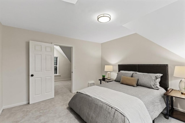 bedroom featuring vaulted ceiling, baseboards, and light carpet