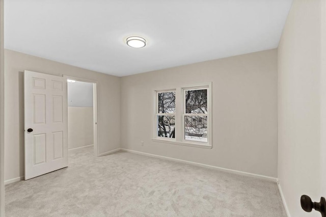 empty room with light carpet and baseboards