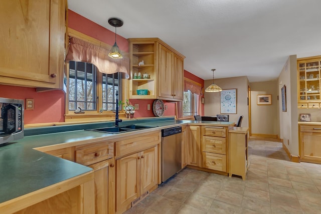 kitchen with a sink, light brown cabinets, stainless steel appliances, a peninsula, and pendant lighting