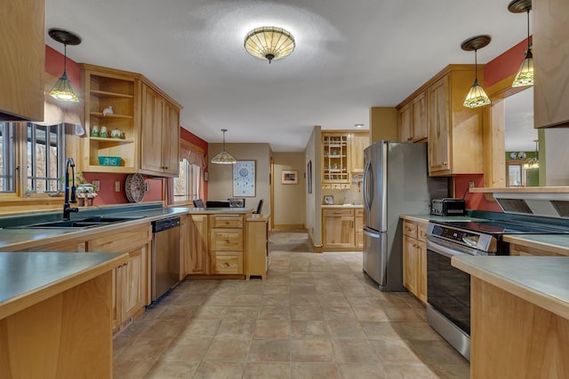 kitchen featuring open shelves, a sink, stainless steel appliances, a peninsula, and pendant lighting