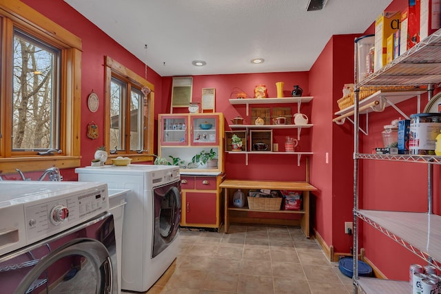 laundry room with washer and dryer, recessed lighting, and baseboards