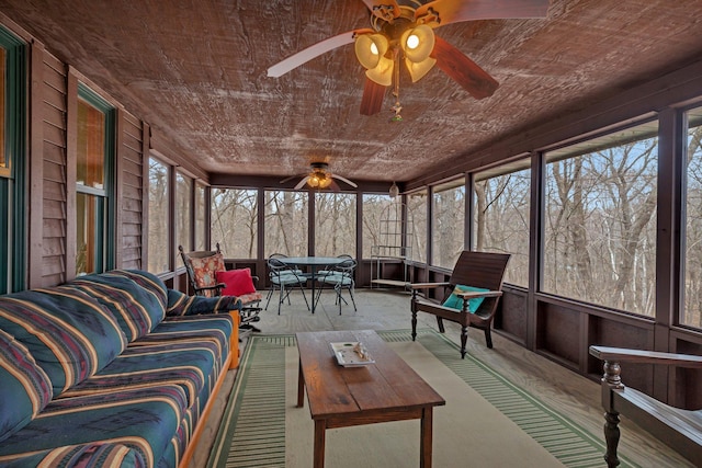 sunroom featuring a ceiling fan, outdoor dining space, and outdoor lounge area
