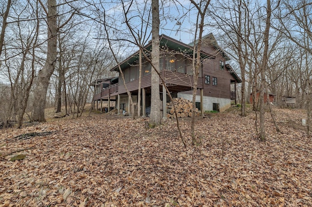 rear view of house with a wooden deck