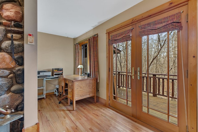 home office featuring baseboards, french doors, and wood finished floors