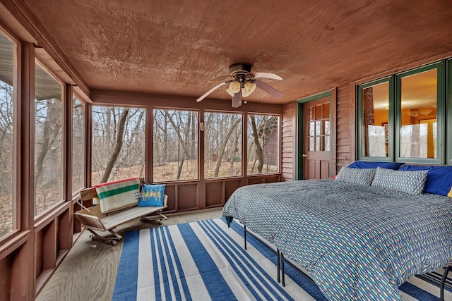bedroom with carpet floors, wood ceiling, and ceiling fan