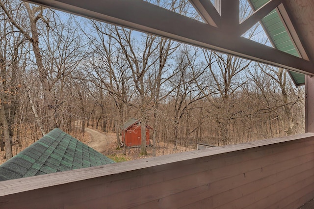 details with a wooded view