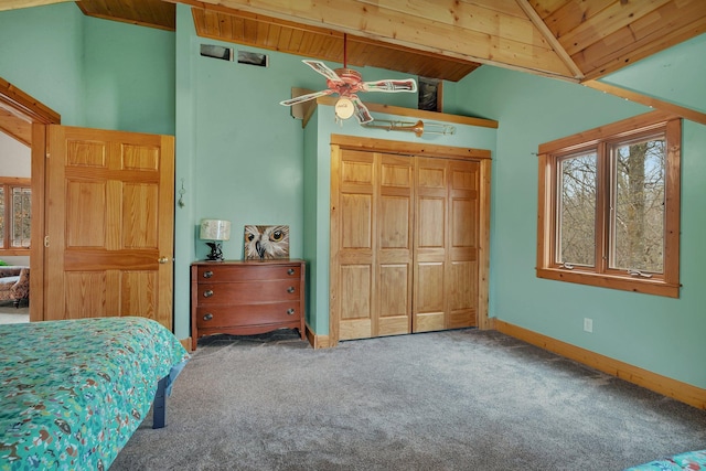 bedroom featuring wooden ceiling, vaulted ceiling with beams, a closet, and carpet floors