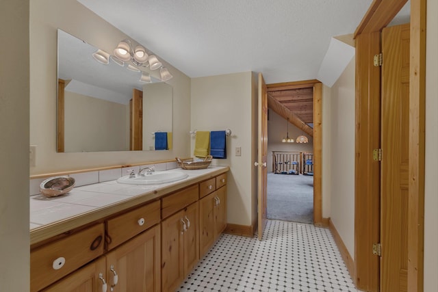 bathroom featuring baseboards and vanity