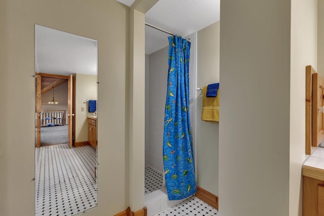 full bath featuring baseboards, a shower stall, and vanity