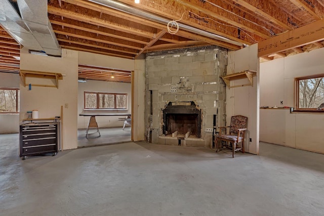 basement with a healthy amount of sunlight and a large fireplace