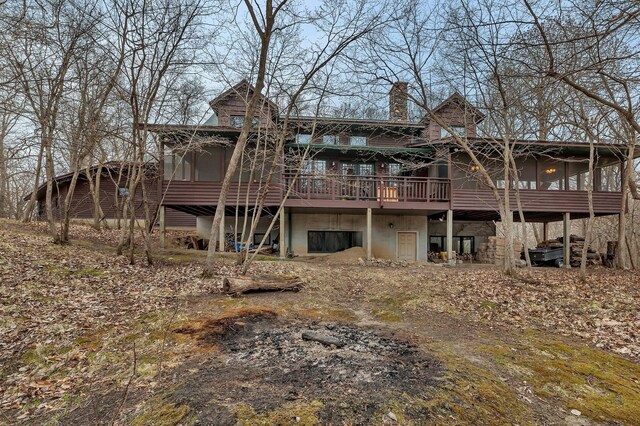 1356 119th St NW, Silver Creek Twp, MN 55362 - rear view of house with a wooden deck, a chimney, and a sunroom