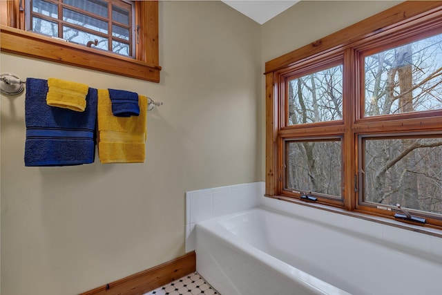1356 119th St NW, Silver Creek Twp, MN 55362 - bathroom with baseboards, a bath, and a wealth of natural light