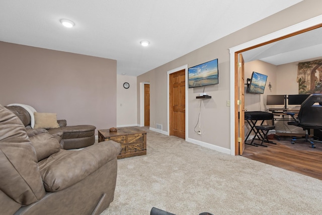 carpeted living room with visible vents and baseboards